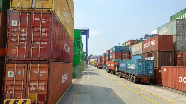 a long line of shipping containers on the side of a road